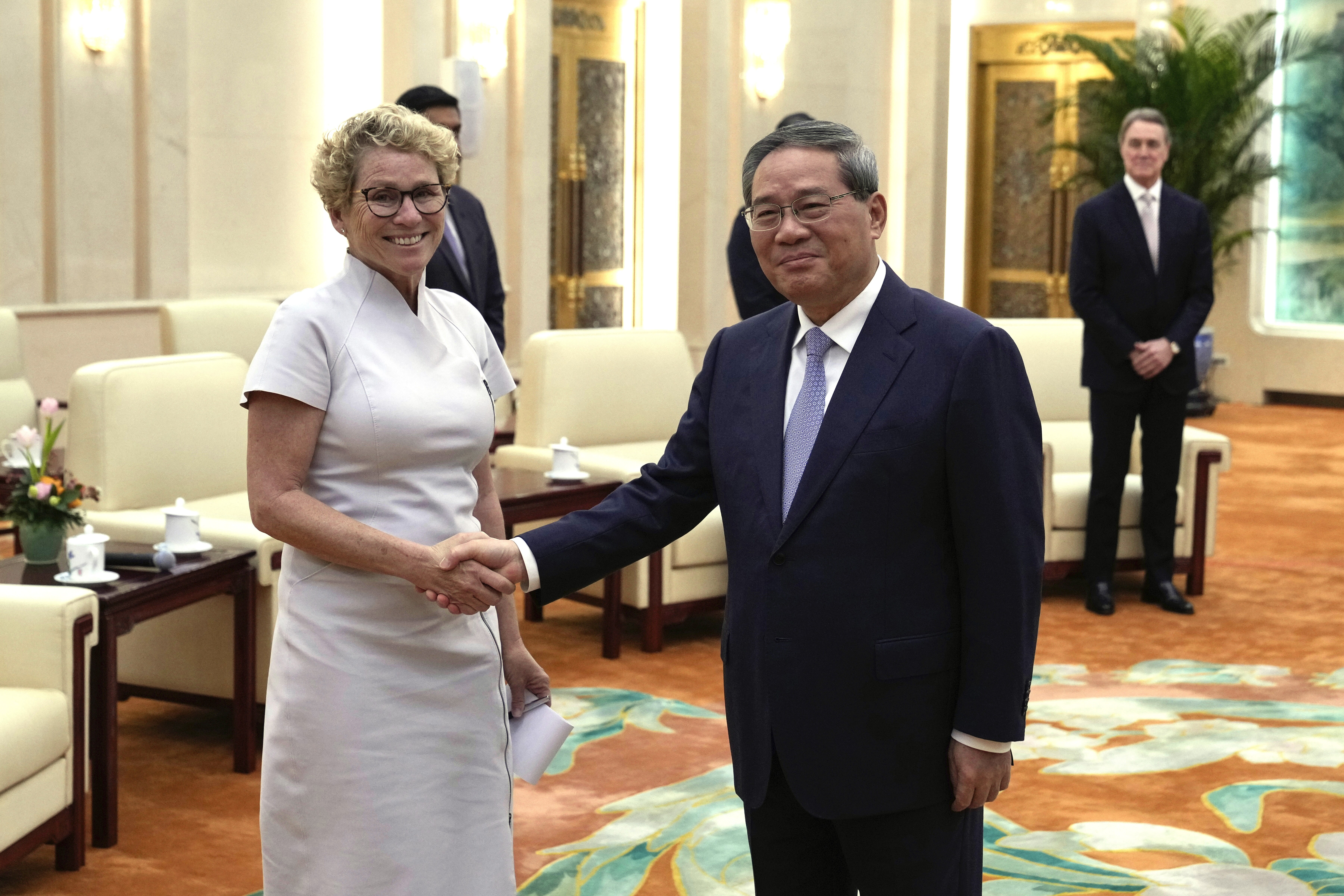 Chrissy Houlahan, Democratic member of House Armed Services Committee, left, poses for a photo with Chinese Premier Li Qiang at the Great Hall of the People in Beijing, China on Sunday.